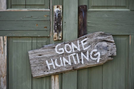 gone hunting driftwood sign hanging on door