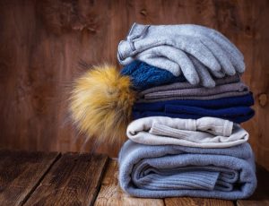 Stack of warm knitted clothes